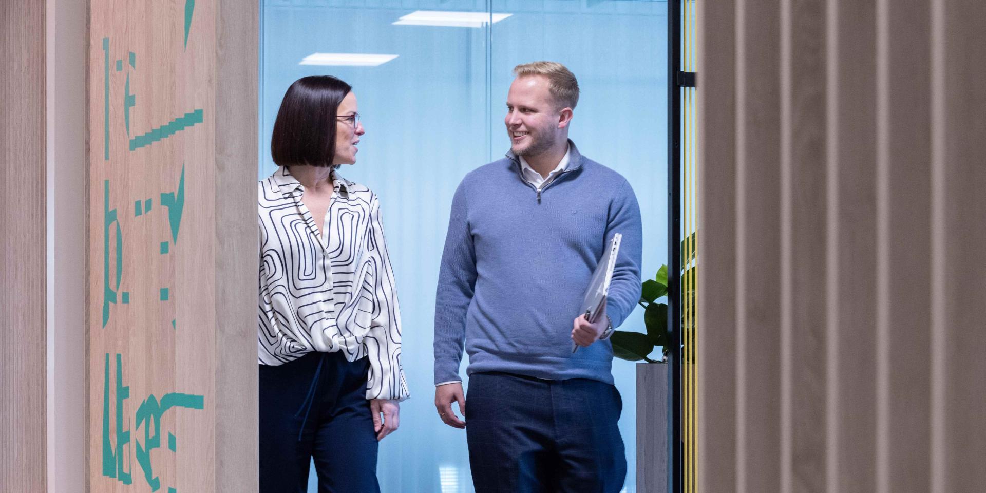 Colleagues walking in office