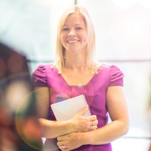 a lady in a purple dress smiling