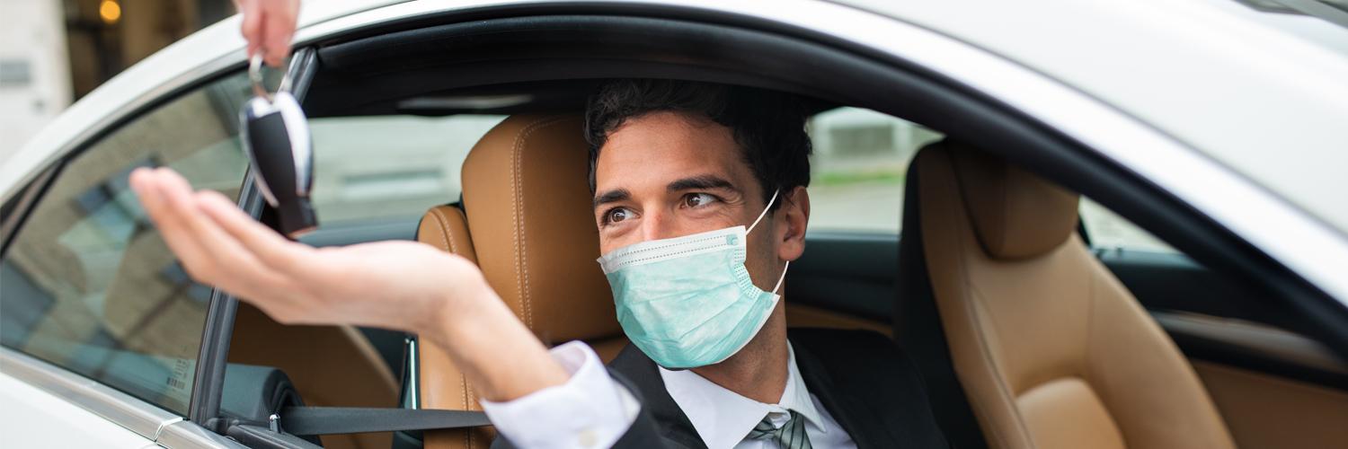man in mask in car